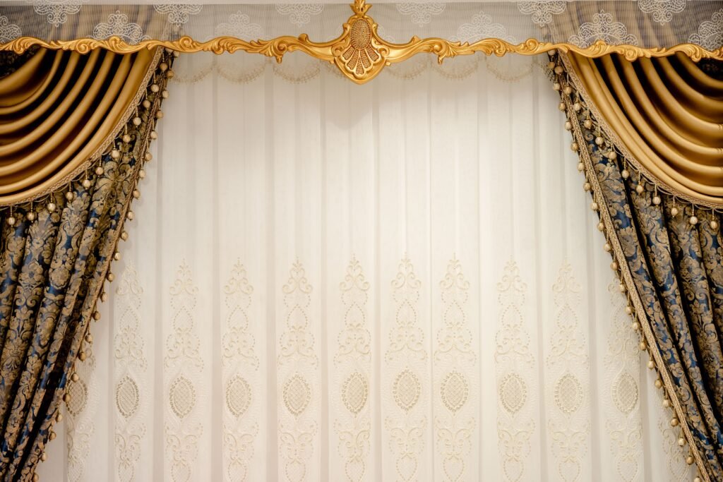 Elegant gold and blue drapes with intricate patterns create a luxurious setting.